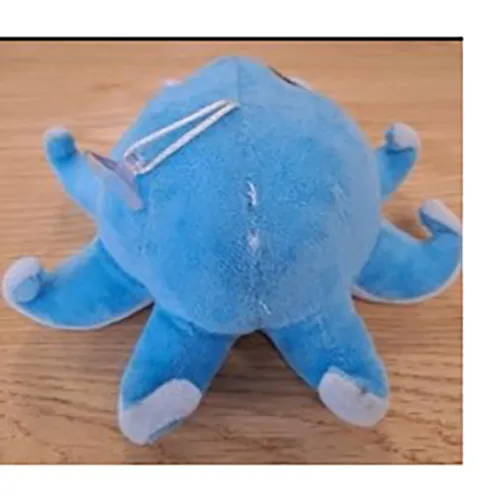 Peluche bleue en forme de poulpe avec une petite ventouse attachée par un cordon.