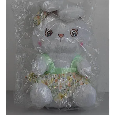 Lapin blanc en peluche dans une robe, avec deux perles cousues sur le visage et un noeud sur la tête. Taille de 40 cm.