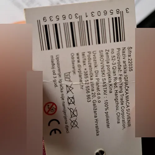 Jouet en peluche en forme de chat gris oblong avec du blanc en dessous