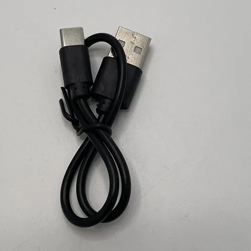 Lampe frontale avec un cordon utilisé pour charger la lampe.