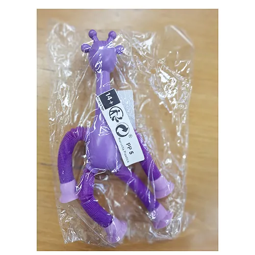 Jouet en plastique en forme de girafe en violet. Les pattes de la girafe peuvent être étendues, et il y a des ventouses aux extrémités des pattes qui peuvent être attachées à une fenêtre, des meubles, etc. Produit vendu en ligne, notamment via Shein (identifiant unique: sl2501076151622677)