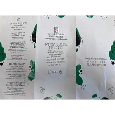 Écharpe bébé en deux parties sans ouvertures intégrées des jambes, noire à l'extérieur, avec un tissu en maille en tissu et des inserts rembourrés blancs dans certaines parties. Produit vendu en ligne, notamment via AliExpress (identifiants uniques: 005007565256736-12000041320277361).