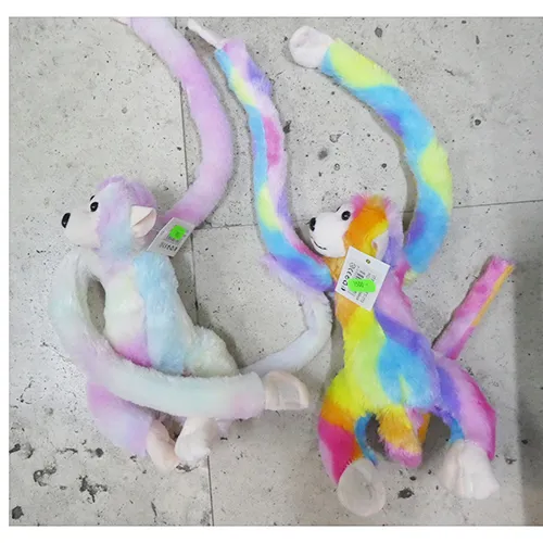 Singe en peluche de couleur arc-en-ciel, émettant un son, avec les mains velcro, les yeux en plastique et le nez.