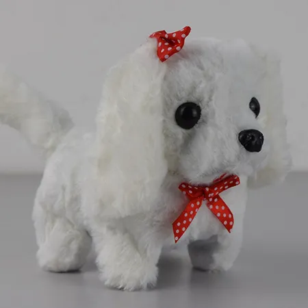 Un jouet souple à batterie en forme de chien avec un arc à pois autour du cou, qui aboie et rampe. Disponible en blanc ou avec des pois noirs ou bruns.