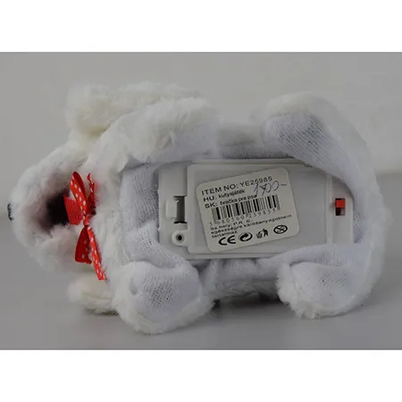 Un jouet souple à batterie en forme de chien avec un arc à pois autour du cou, qui aboie et rampe. Disponible en blanc ou avec des pois noirs ou bruns.